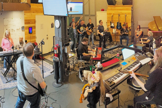 People playing instruments in a band as part of a Community Jam session