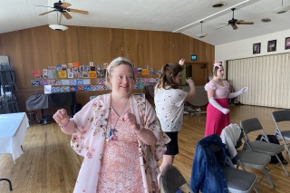 Three people dancing in a room