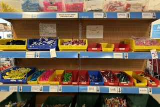 Schoolhouse Supplies shelves stocked with markers, highlighters, rulers and glue sticks