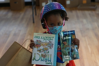 Children's Book Bank girl with bike helmet and books