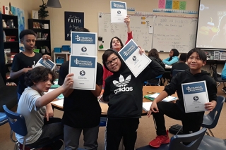 Kids holding Financial Beginnings Oregon materials