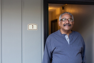 Man at door of his home