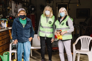 Man visiting with two volunteers