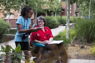 A girl talking with a woman in a wheelchair