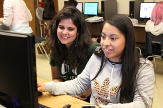 Photo of two students at a computer