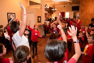 Photo of kids raising their hands