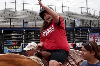 Photo of a girl horseback riding