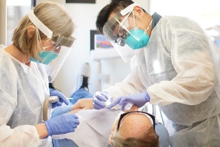 Photo of two doctors treating a patient